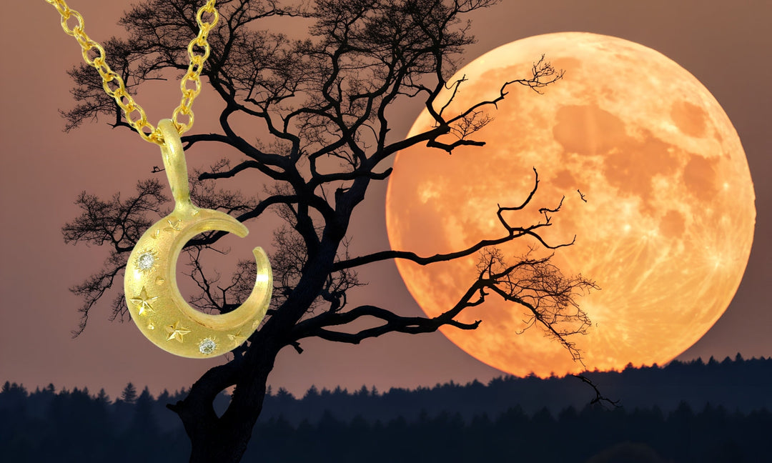 yellow gold crescent moon pendant with diamonds in frontn of super moon