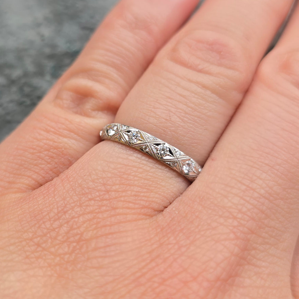 Close-up of woman wearing Serpentis platinum diamond eternity band from Alara Jewelry