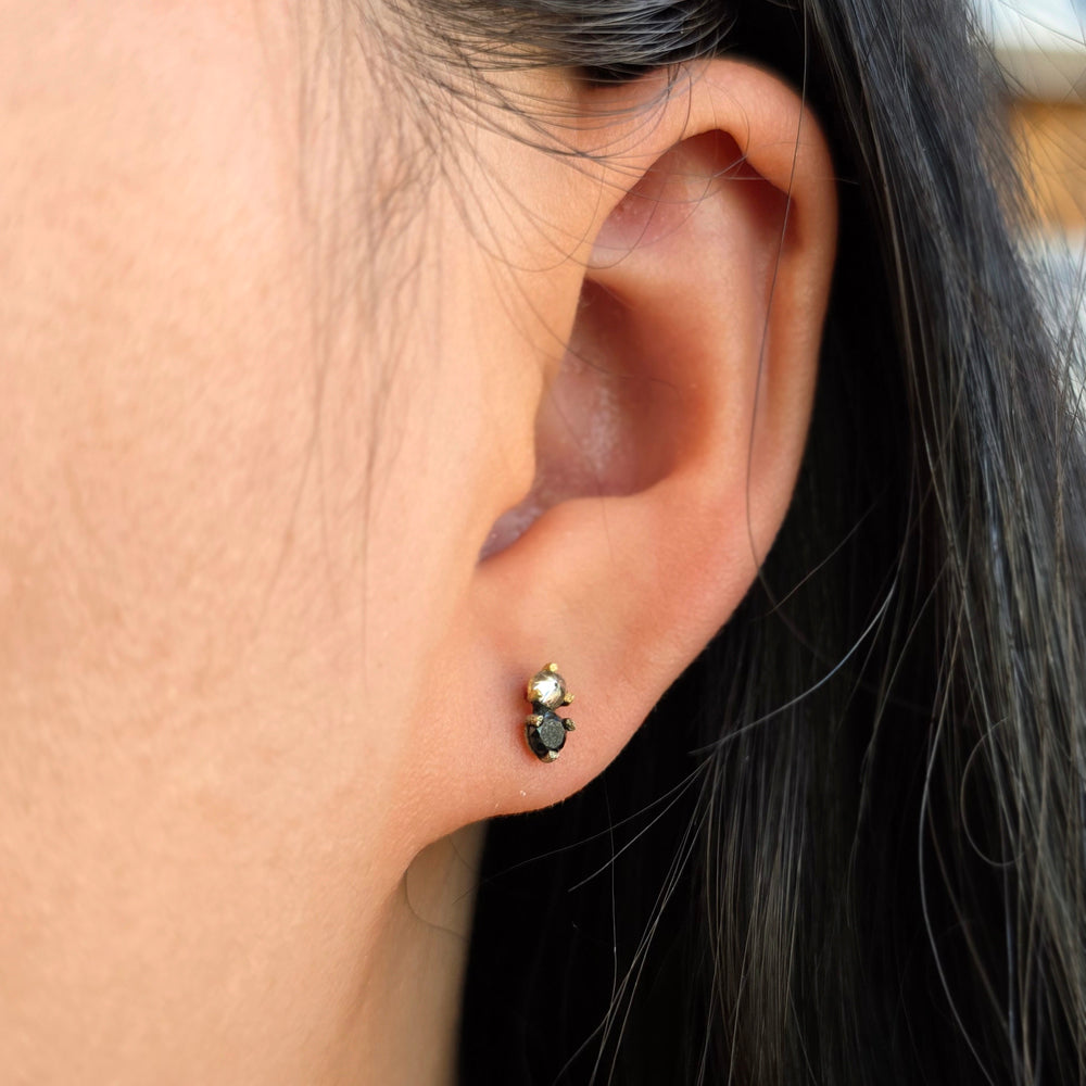 Woman wearing Nightpoint inverted diamond studs by Todd Pownell from Alara Jewelry