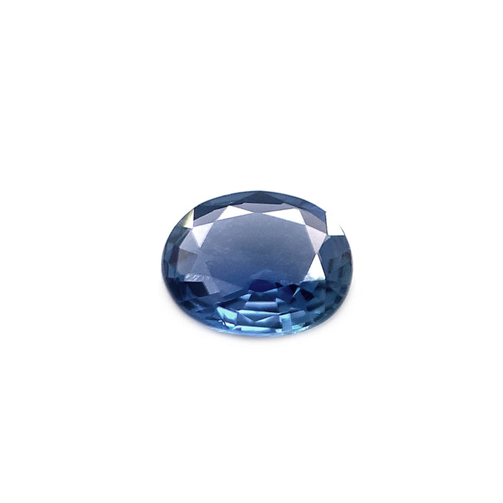 An oval-cut blue Yogo sapphire gemstone on a plain background