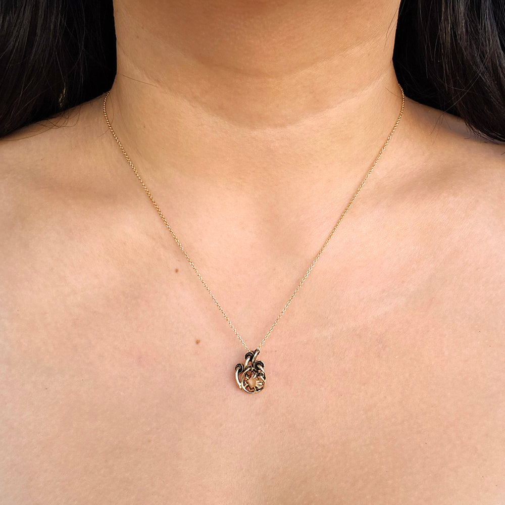 Woman wearing Mushroom Montana sapphire pendant from Alara Jewelry
