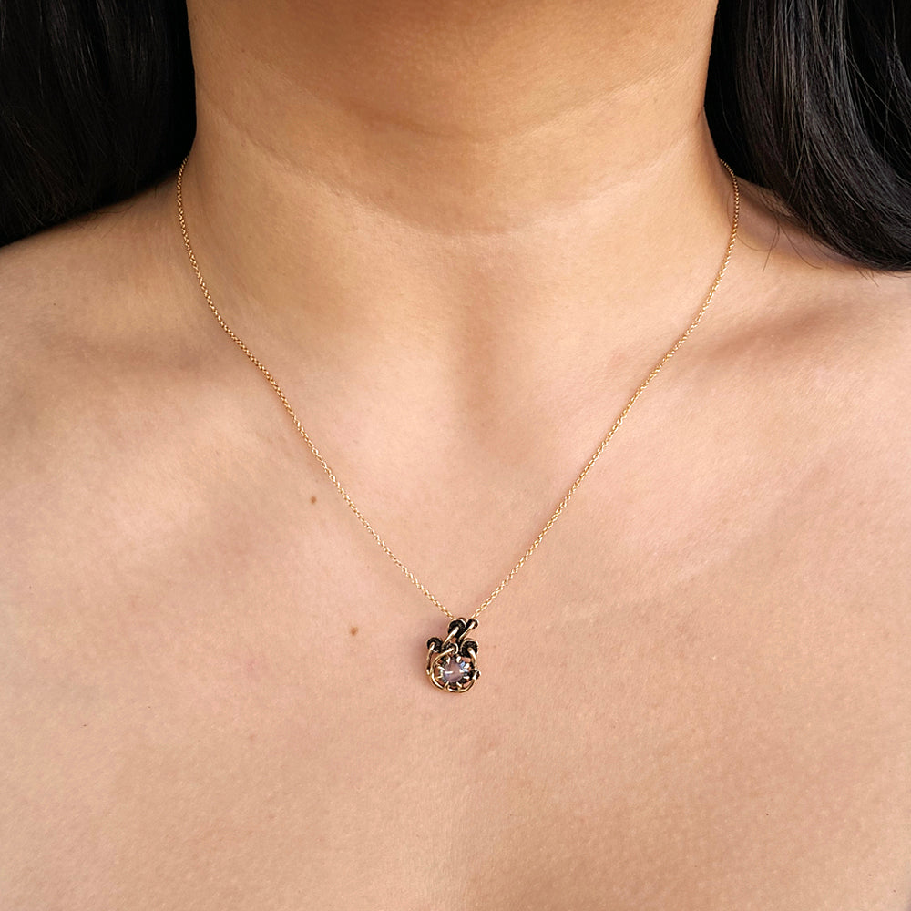 Woman wearing Mushroom Montana sapphire pendant from Alara Jewelry