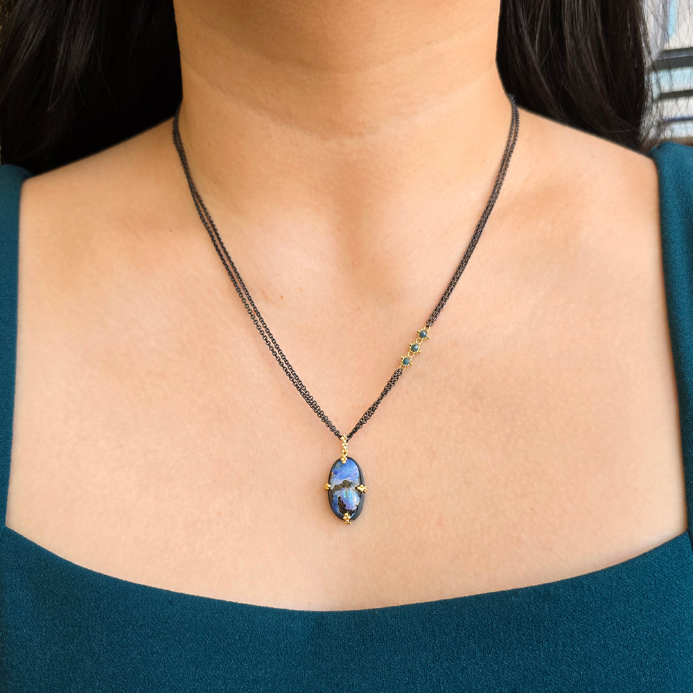 Woman wearing Aurora Yowah opal necklace by Amáli from Alara Jewelry