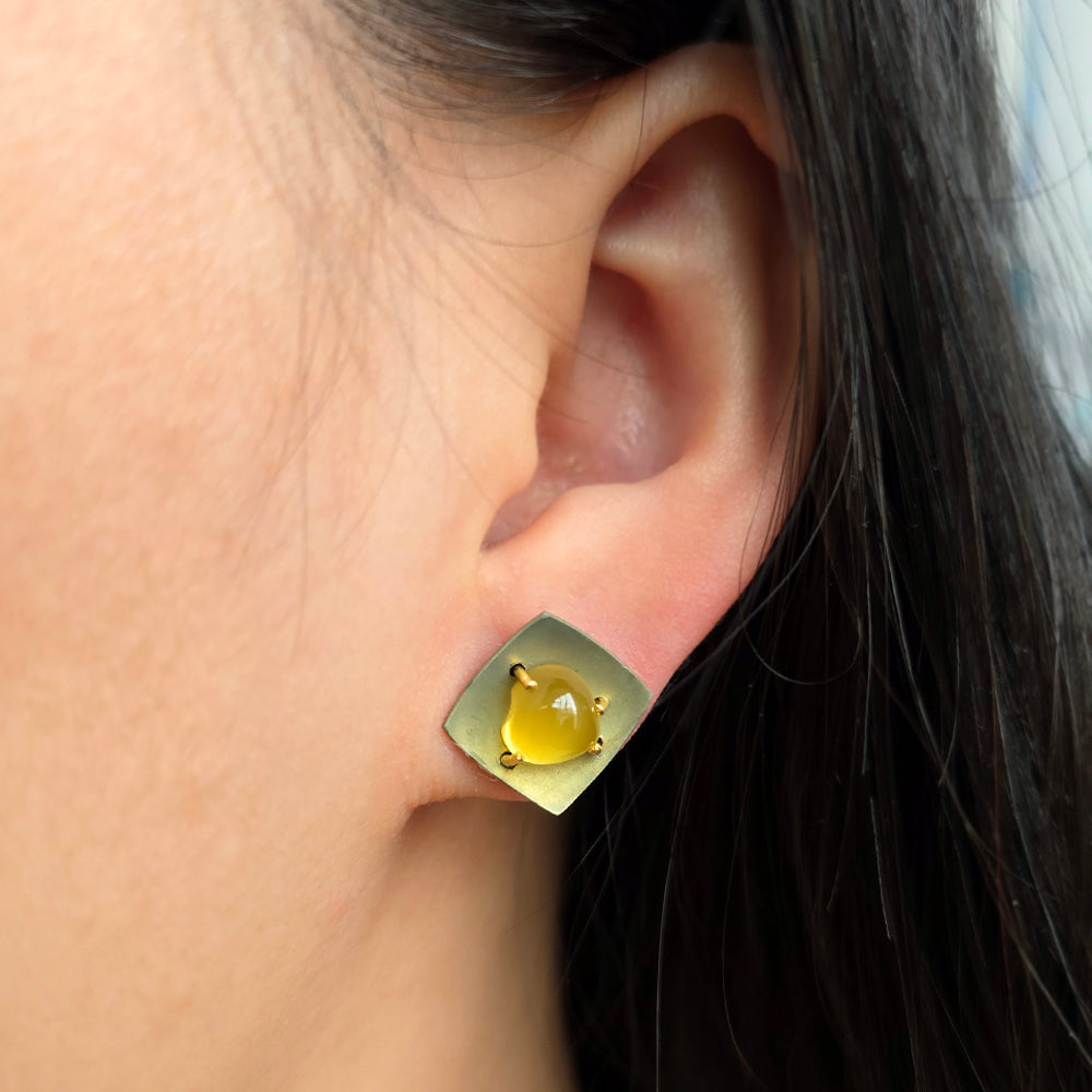 Woman wearing Sunroom yellow beryl earrings by Michael Jensen from Alara Jewelry