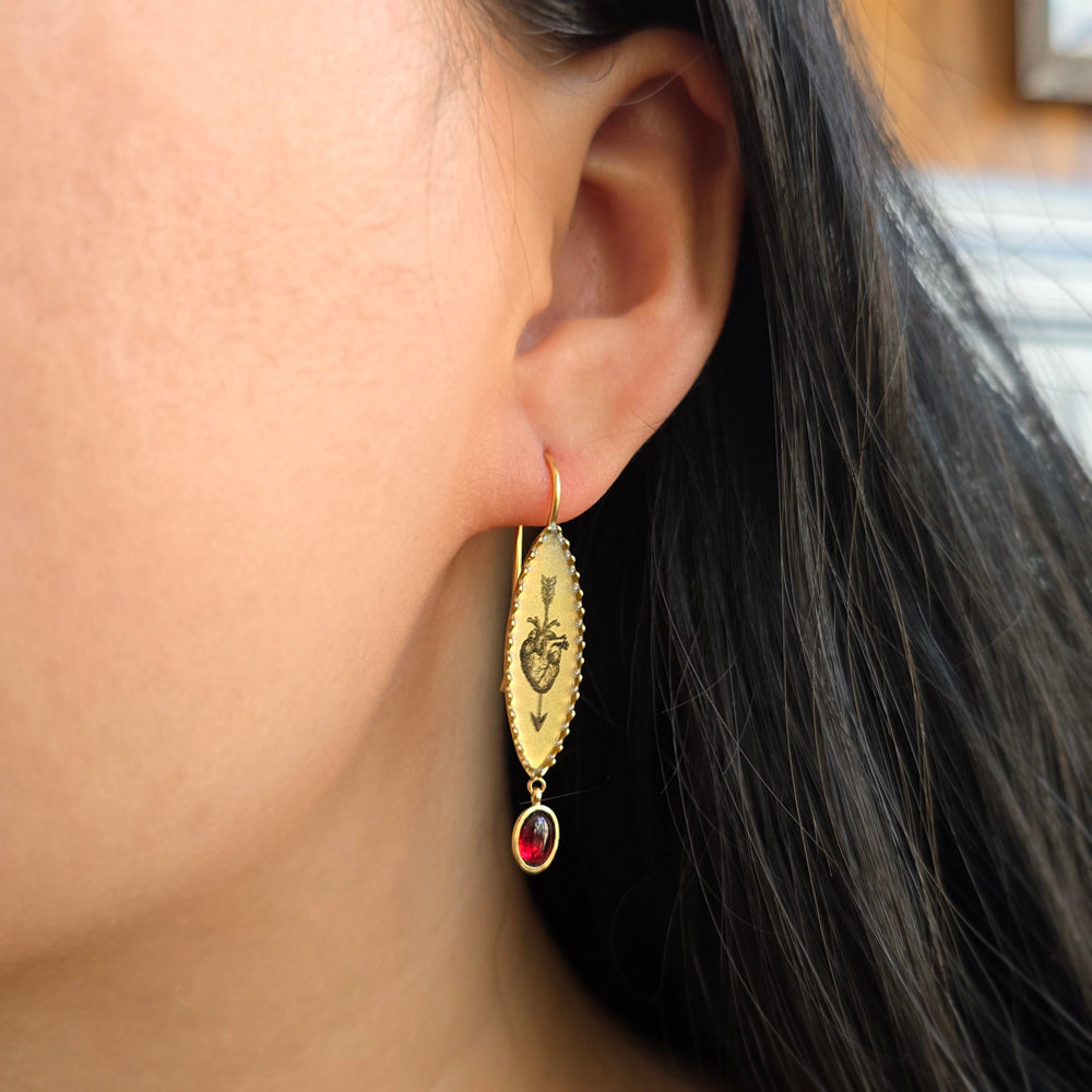 Woman wearing Bleeding Lover garnet earrings by Anna Bánkuti from Alara Jewelry