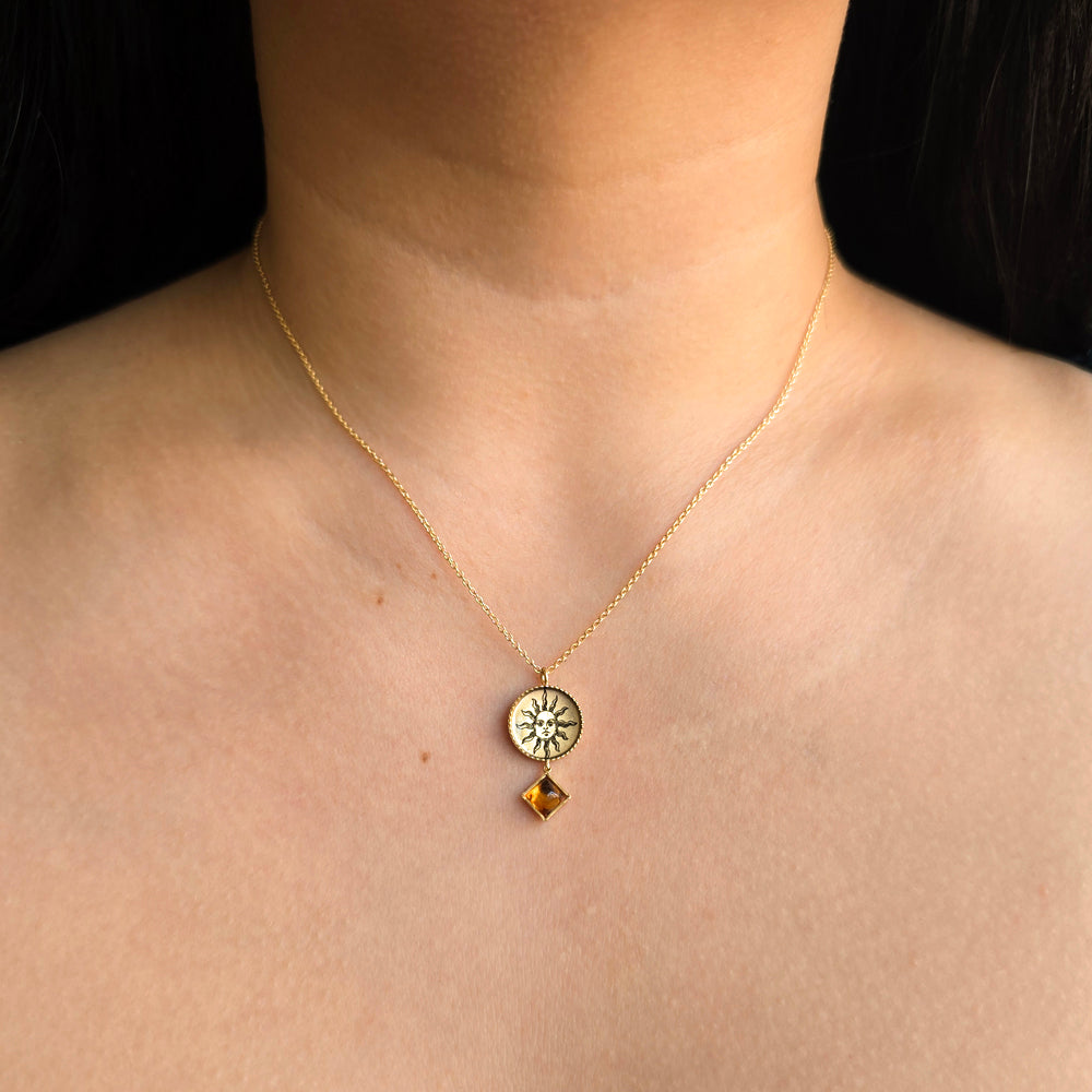 Woman wearing Pocketful of Sunshine citrine pendant by Anna Bánkuti from Alara Jewelry