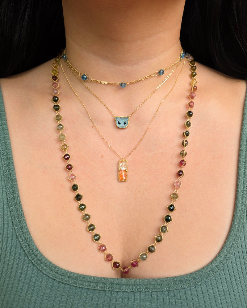 Woman wearing Heat Haze sunstone necklace layered with others by Amáli from Alara Jewelry