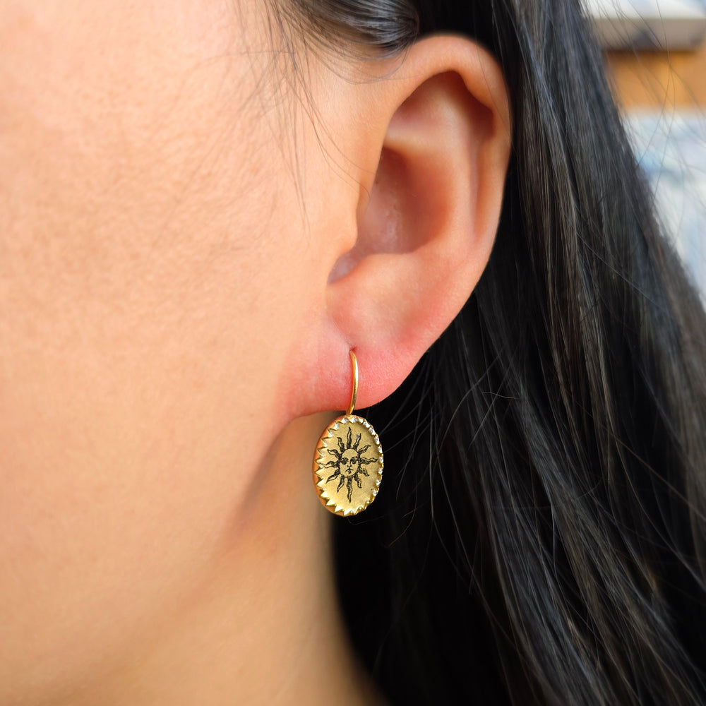 Mismatched celestial earrings with etched sun and crescent moon