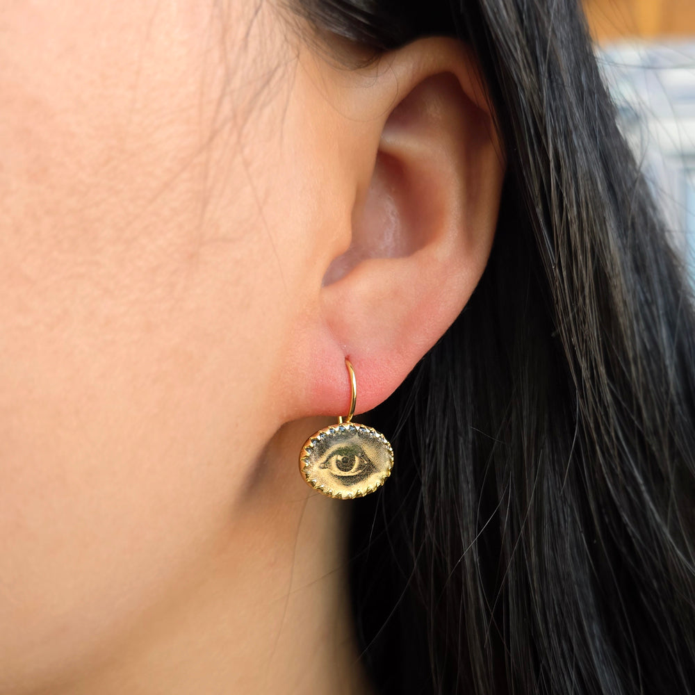 Woman wearing Lover's Eye earrings by Anna Bánkuti from Alara Jewelry