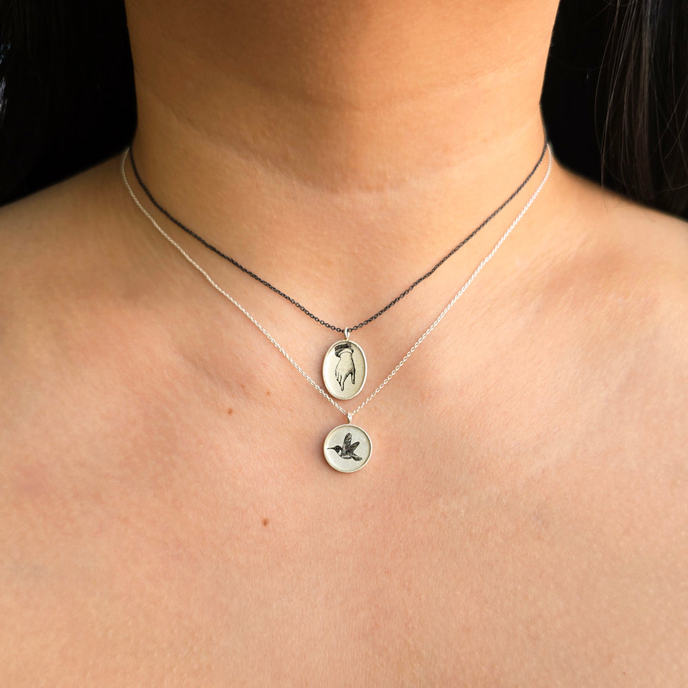 Woman wearing Guiding Hand pendant necklace by Anna Bánkuti from Alara Jewelry