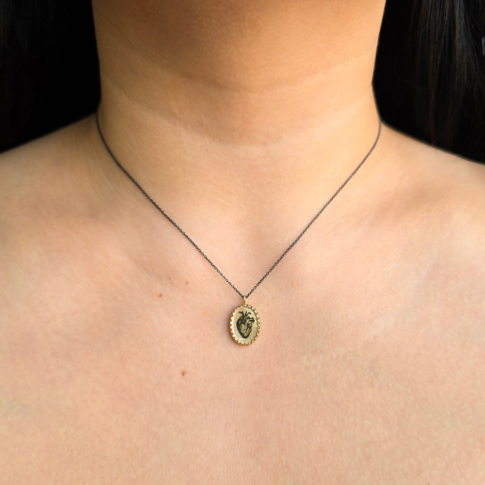 Woman wearing Brave Heart anatomical heart necklace by Anna Bánkuti from Alara Jewelry