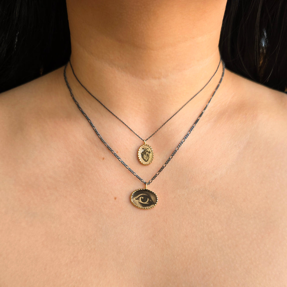 Woman wearing Brave Heart anatomical heart necklace and others by Anna Bánkuti from Alara Jewelry
