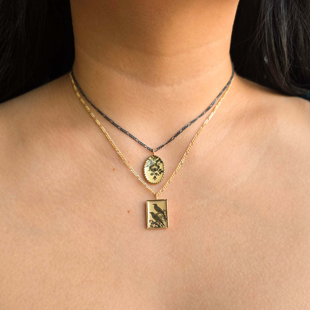 Woman wearing The Messengers crow pendant necklace by Anna Bánkuti from Alara Jewelry