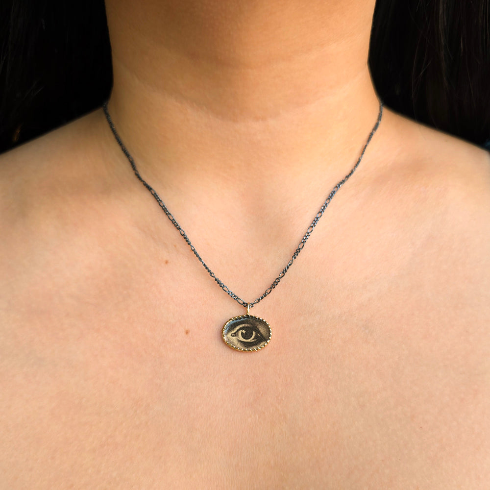 Woman wearing Lover's Eyes pendant necklace by Anna Bánkuti from Alara Jewelry