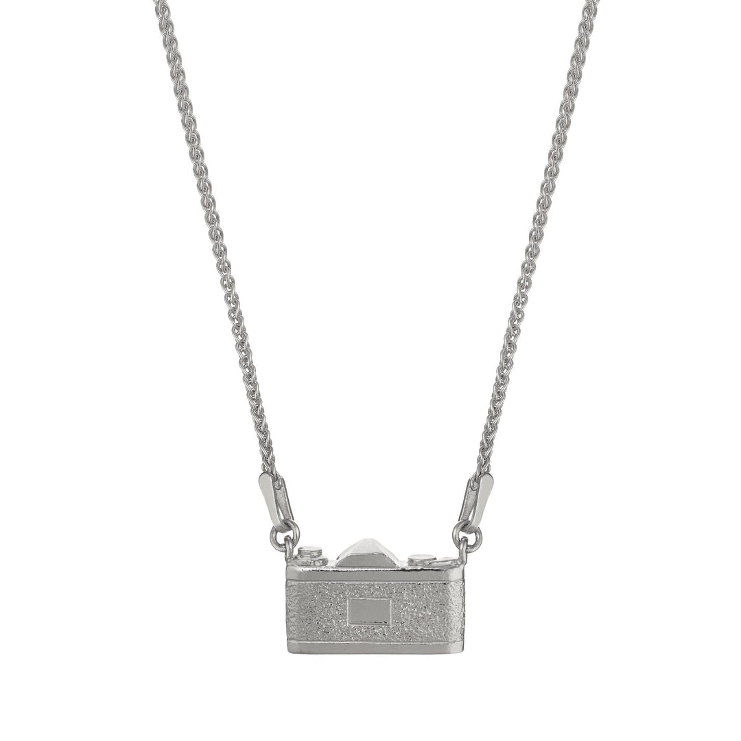 Close-up of hand-detailed vintage camera pendant