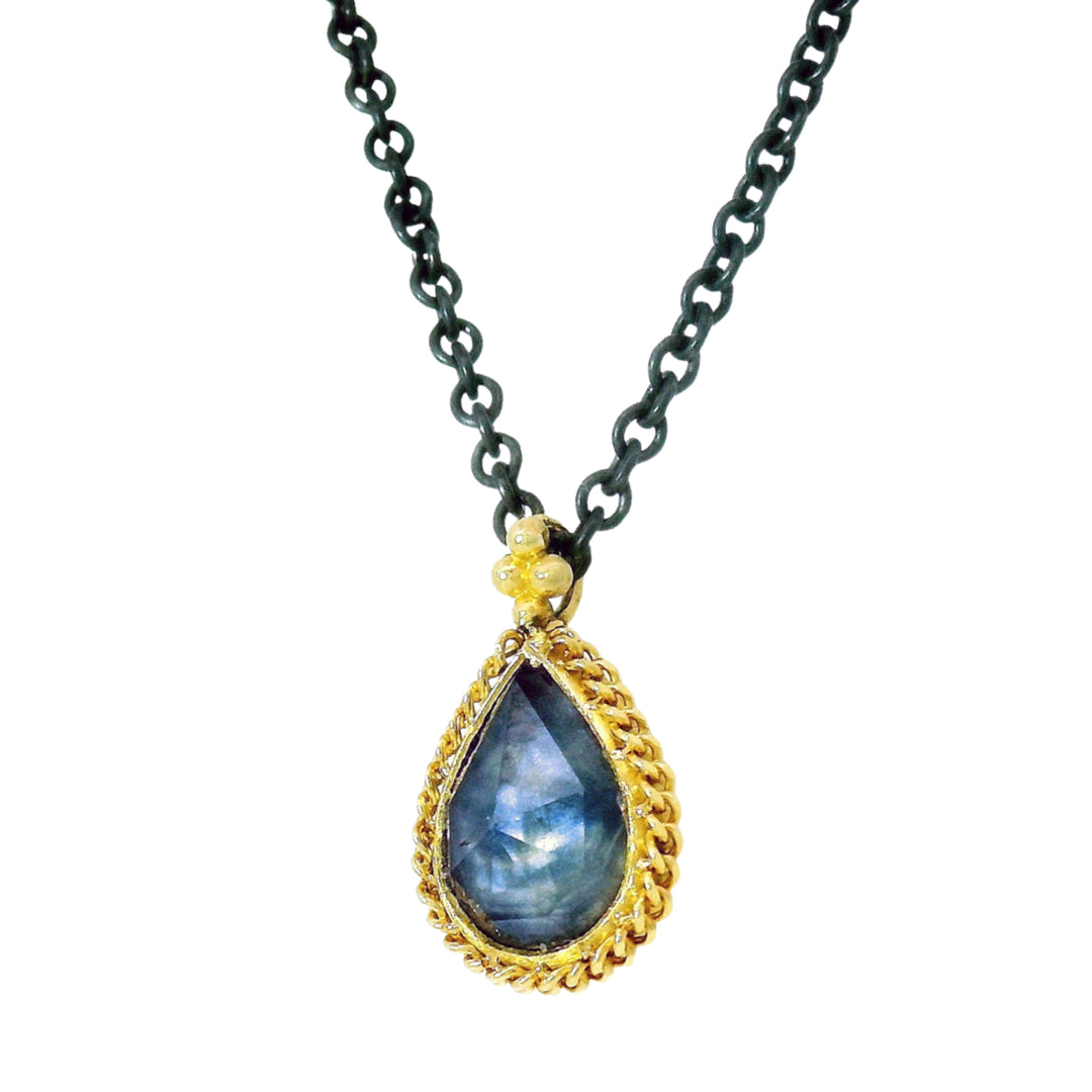Close-up of rose-cut Montana sapphire showing soft blue color