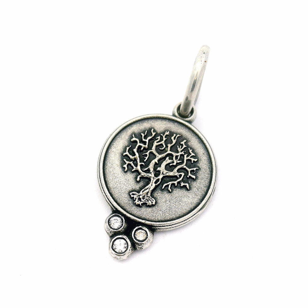 Close-up of sculpted Tree of Life pendant with bezel-set diamonds