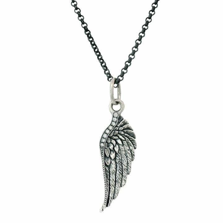 Silver wing-shaped pendant on a chain against a white background