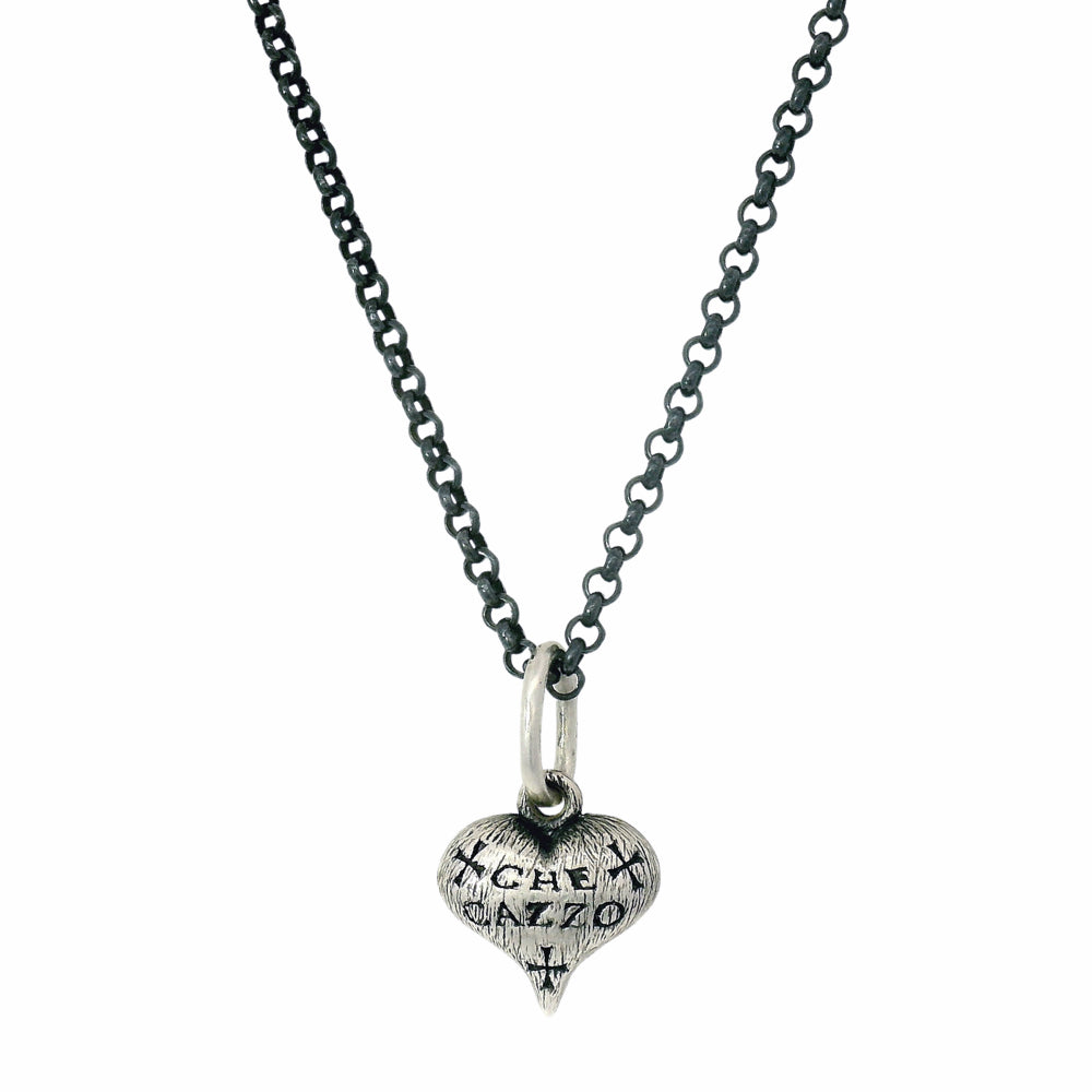 Hand-carved sterling silver heart charm by Erica Molinari with engraved detail