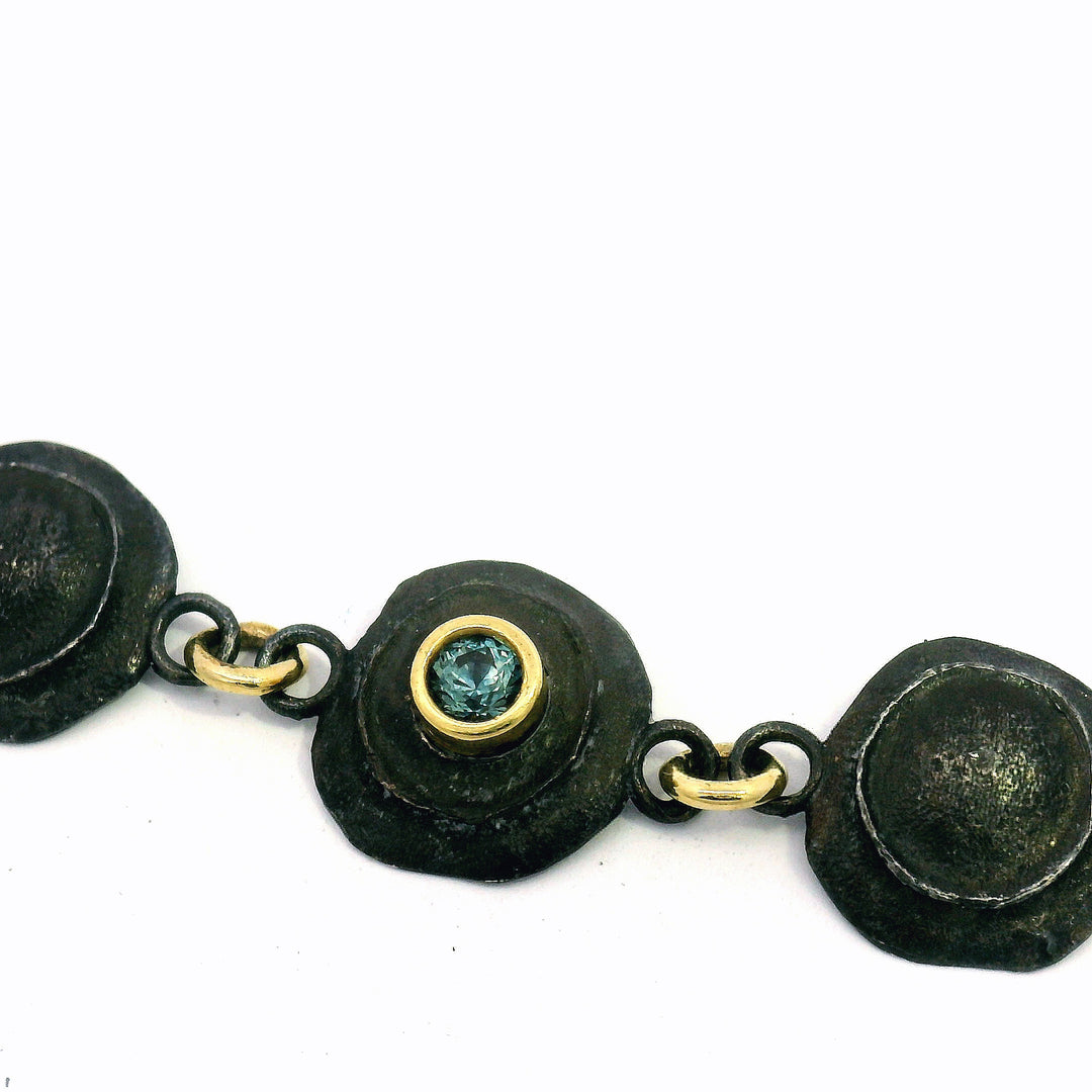 Textured oxidized sterling silver link bracelet with yellow gold and sapphire accents
