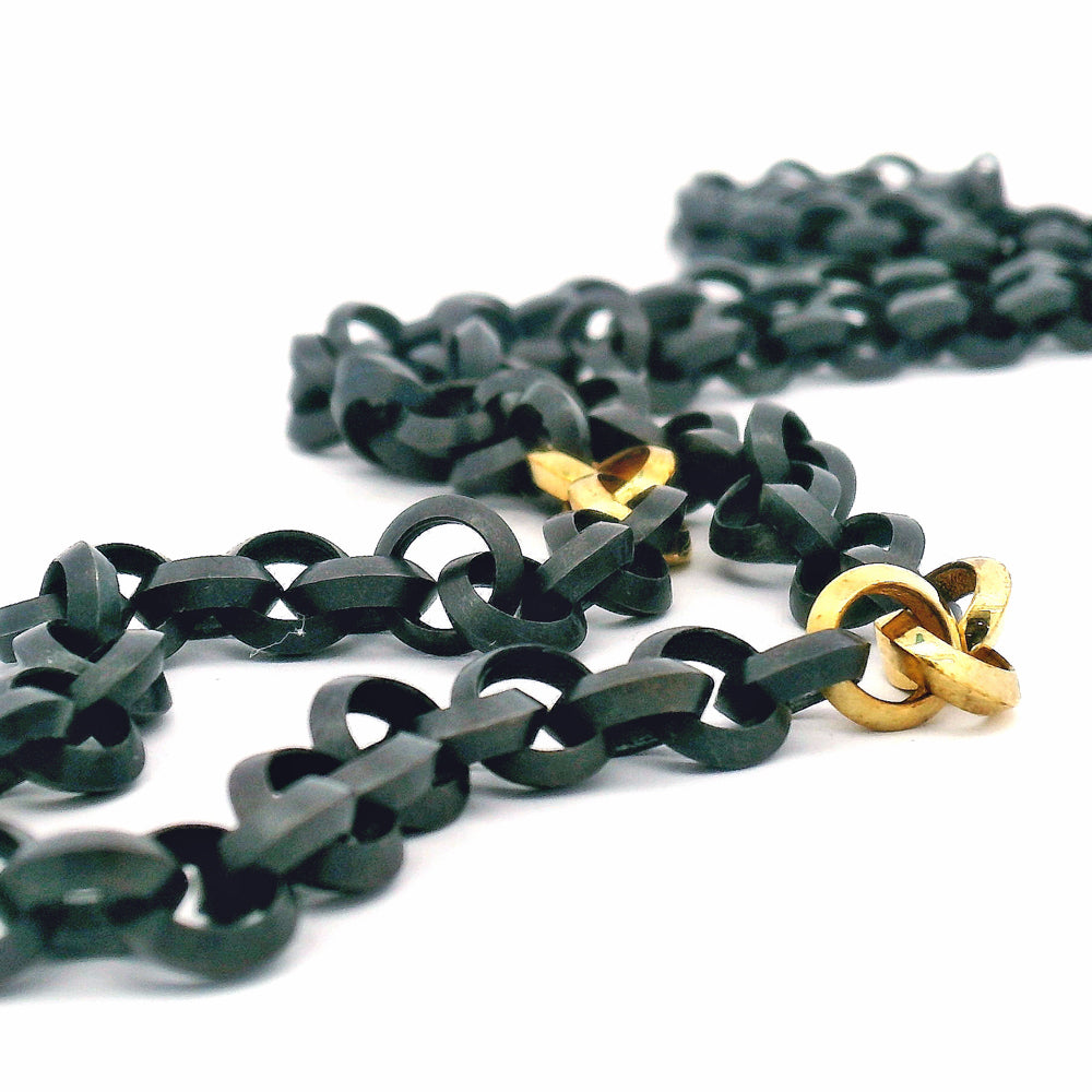 Three Strikes two-tone necklace in oxidized silver and 18K gold