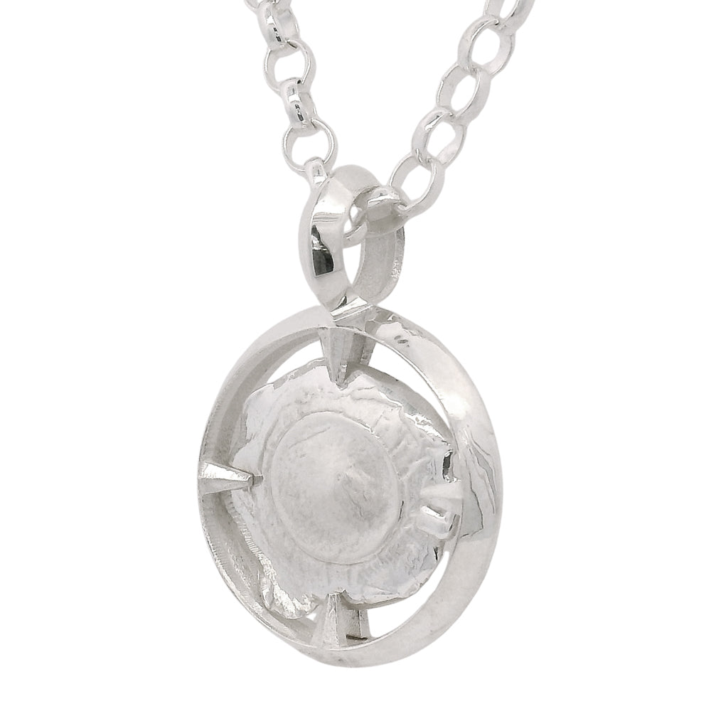 Close-up of organic bullet texture in sculptural silver frame