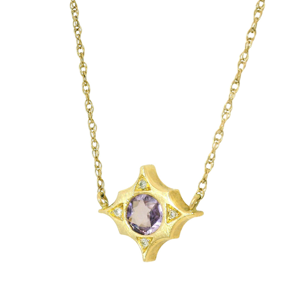 East-west sapphire pendant with diamond accents at cardinal points