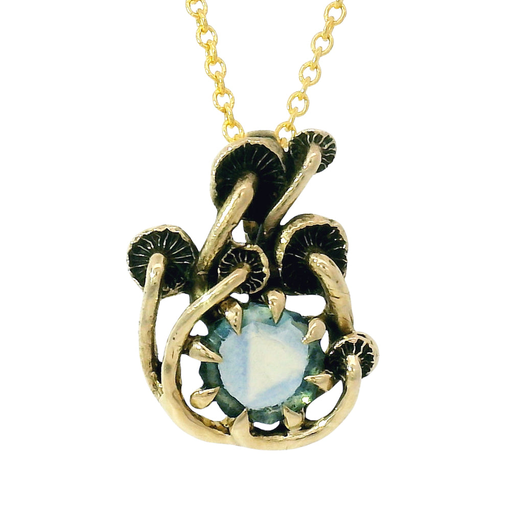 Close-up of light green-blue Montana sapphire and mushroom setting