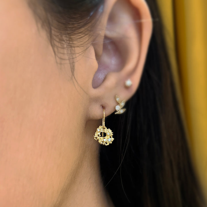 Woman modeling Nebula earrings by Michele Scholnick