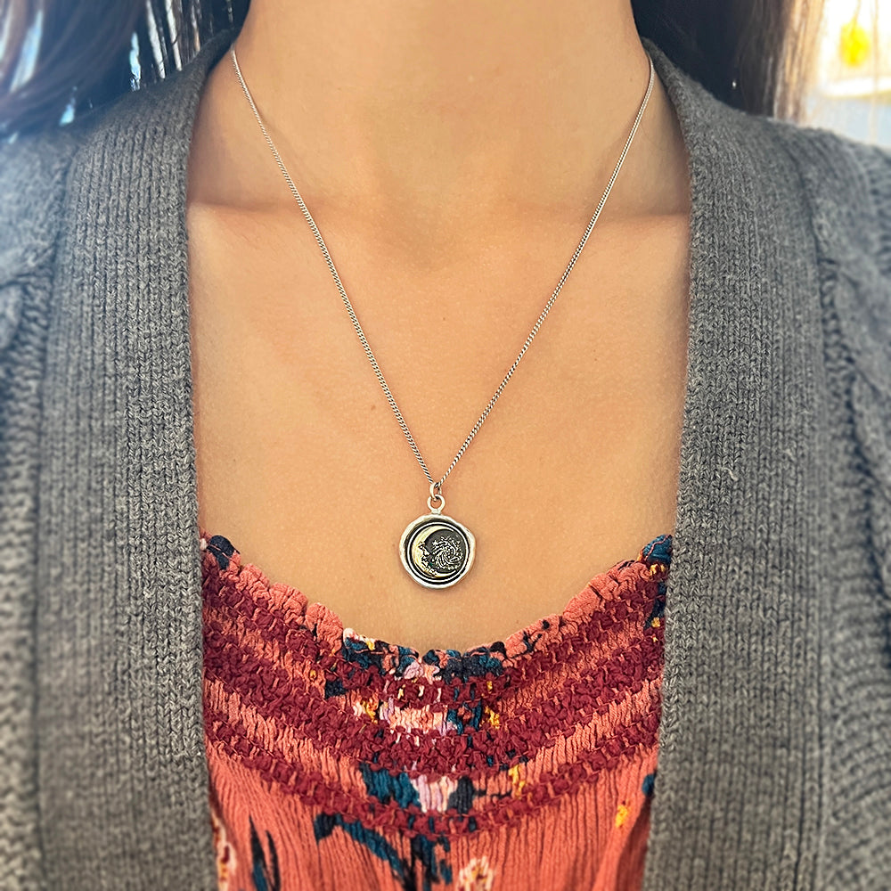 Woman wearing Trust the Universe celestial necklace by Pyrrha from Alara Jewelry