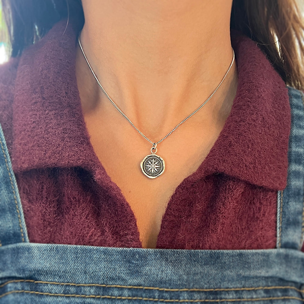 Woman wearing Direction compass talisman necklace by Pyrrha from Alara Jewelry