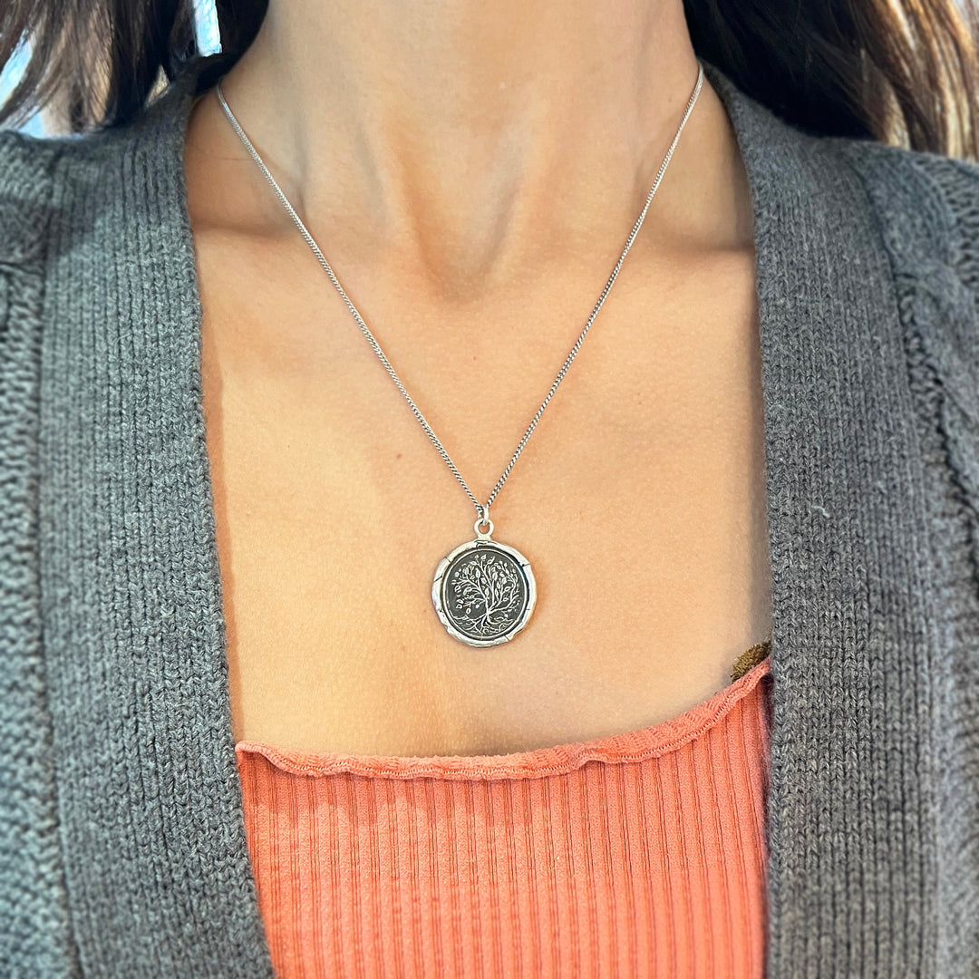 Woman wearing Tree of Life talisman necklace by Pyrrha from Alara Jewelry