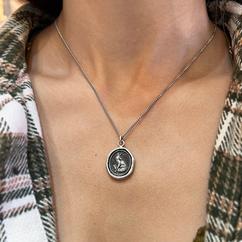 Woman wearing Trust in Yourself fox talisman necklace from Alara Jewelry