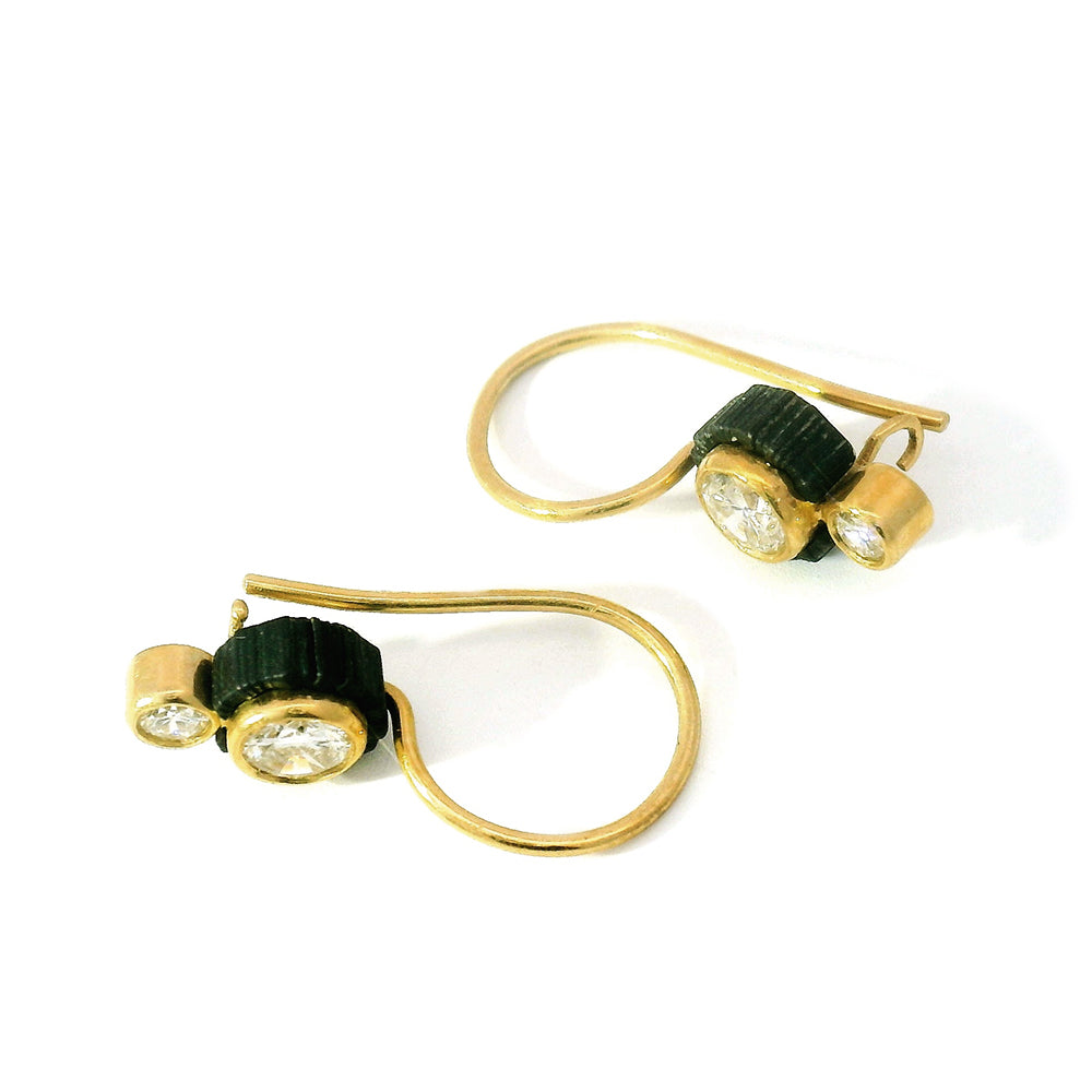 Close-up of diamond detail set against blackened cobalt chrome drop