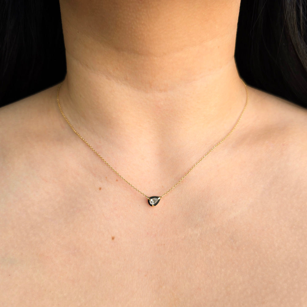 Woman wearing Umbra pear-shaped diamond necklace by René Escobar from Alara Jewelry