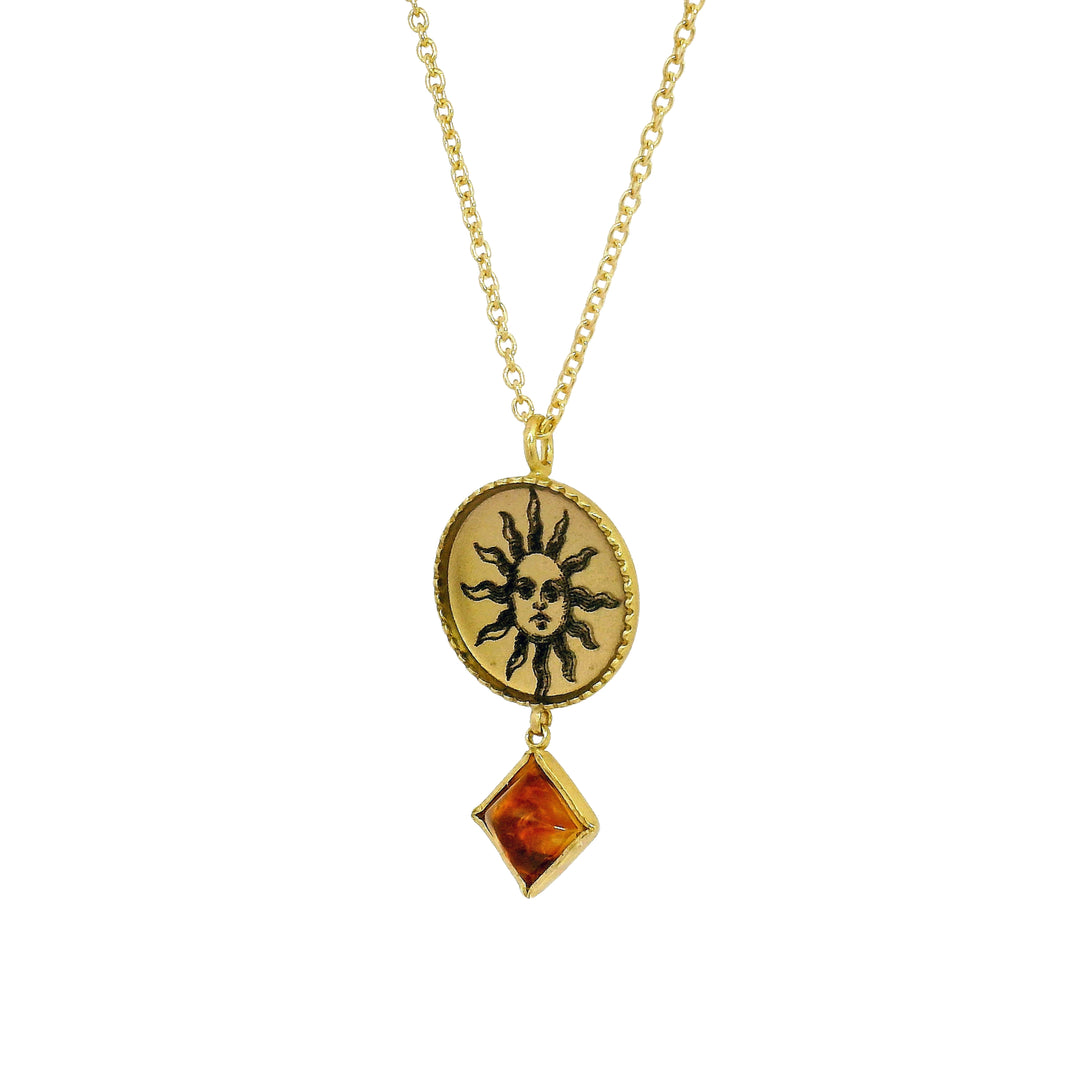 Close-up of celestial sun illustration and citrine cabochon detail