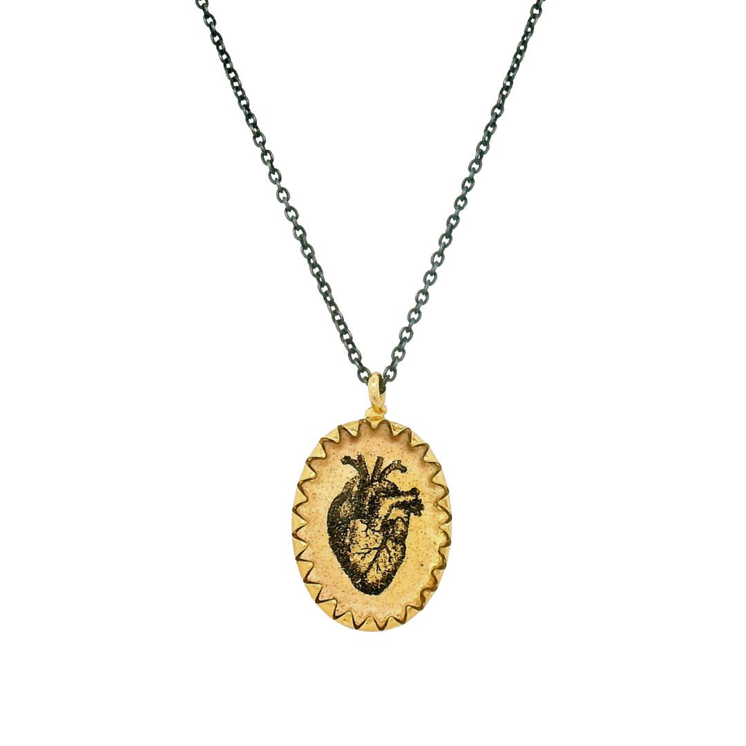 Close-up of anatomical heart illustration on Victorian-inspired pendant