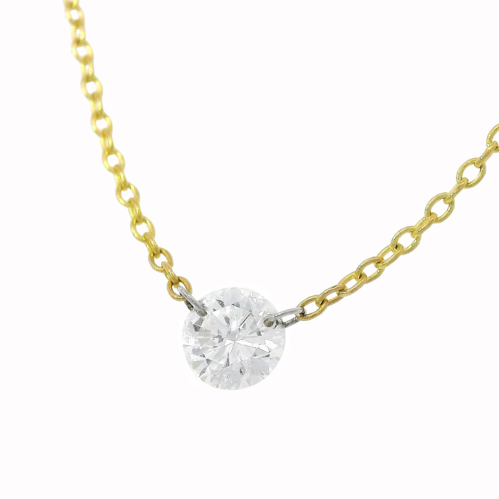 Close-up of round brilliant diamond floating on gold chain
