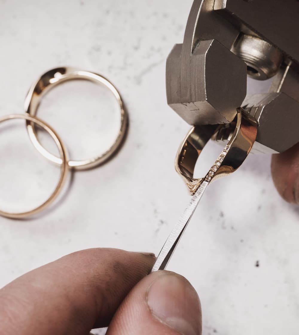 Close up of a jeweler setting a ring