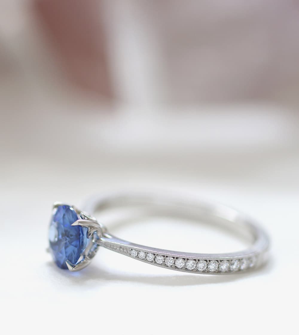 Silver ring with diamonds and a sapphire.