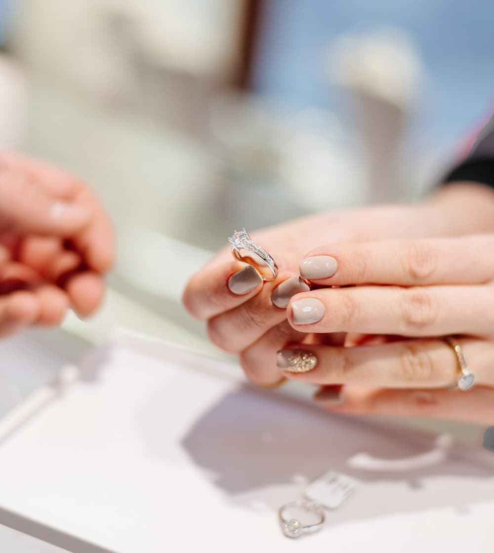 Close up of a person trying on a ring