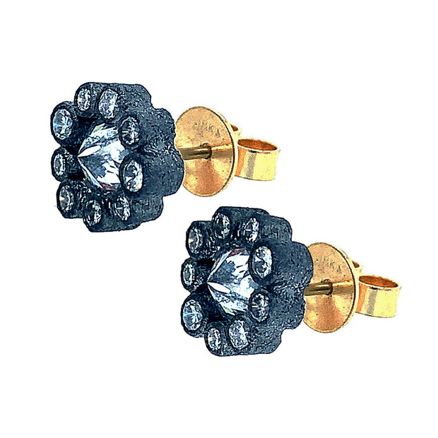 Blackened 14 karat white gold  bezels set upon,18 karat yellow gold post. Studs are encrusted with inverted  brilliant round-cut (center) diamonds (1.11ctw), surrounded by a halo (0.70ctw) with nine brilliant-cut round diamonds.  